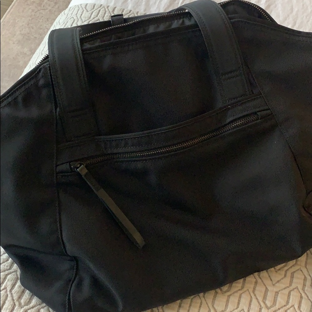 Black lulu workout bag with straps for yoga mat.
